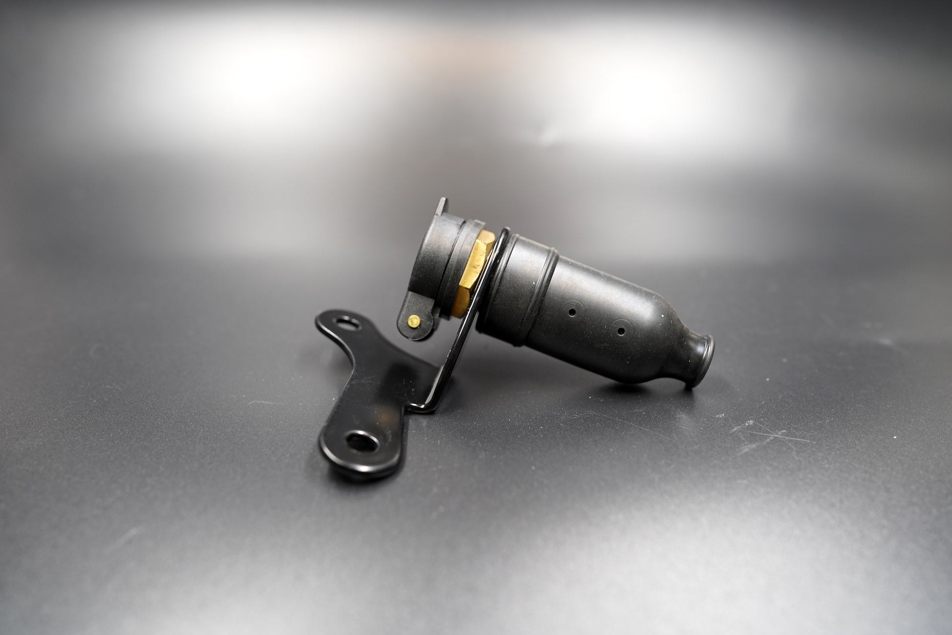 Side view of assembled 12V socket on matte surface 