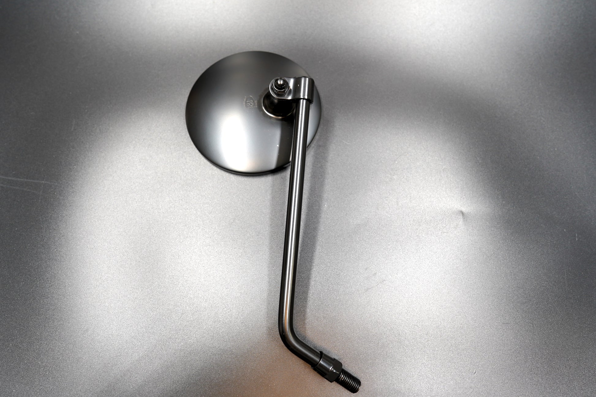 Matte black round motorcycle mirror flat lay

