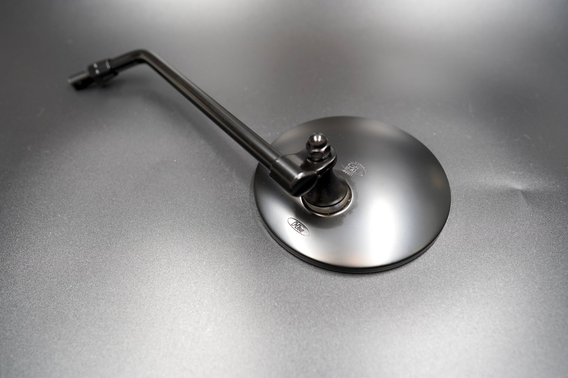 Close-up of matte black mirror glass and edge


