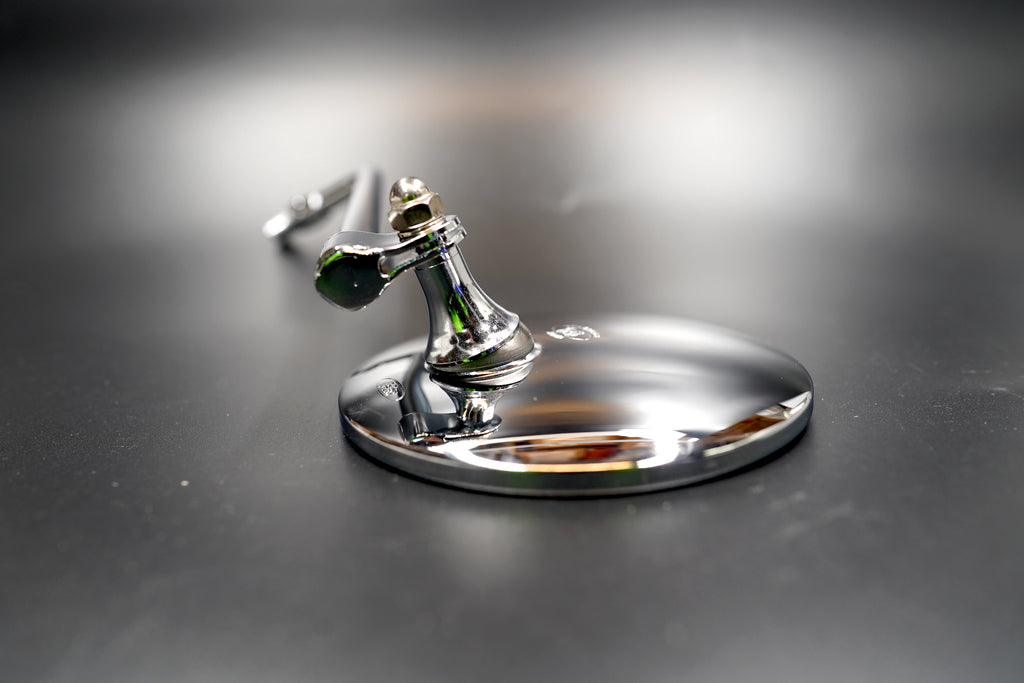 Close-up of chrome motorcycle mirror glass and rim


