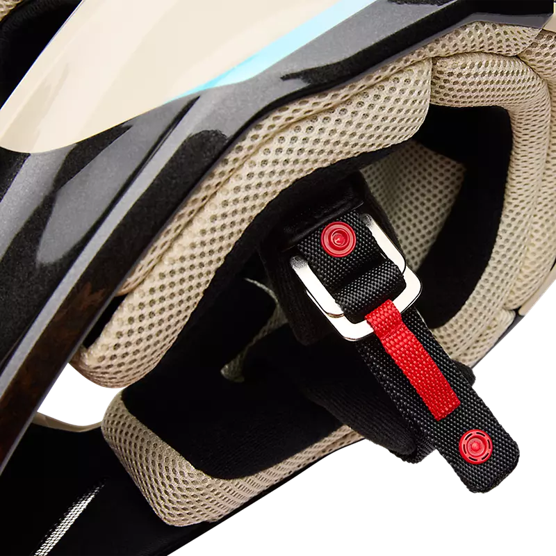 Detail shot of FOX V1 Hello Future Helmet chin strap with quick-release buckle and padded liner.