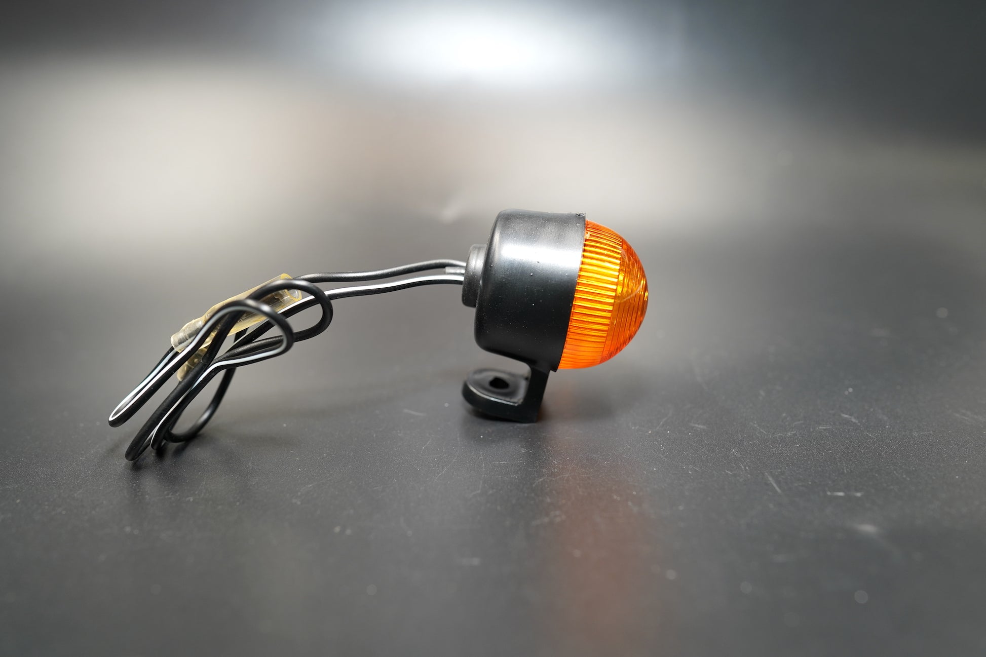 Close-up of single amber turn signal highlighting impact-resistant polycarbonate lens.