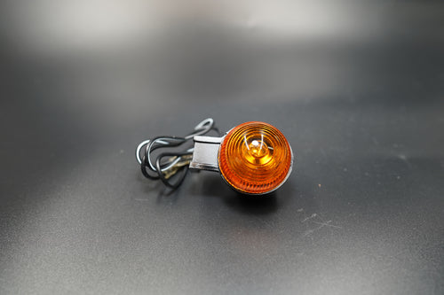 Side angle showing bullet-shaped amber lenses and durable rubber stems for vibration resistance.