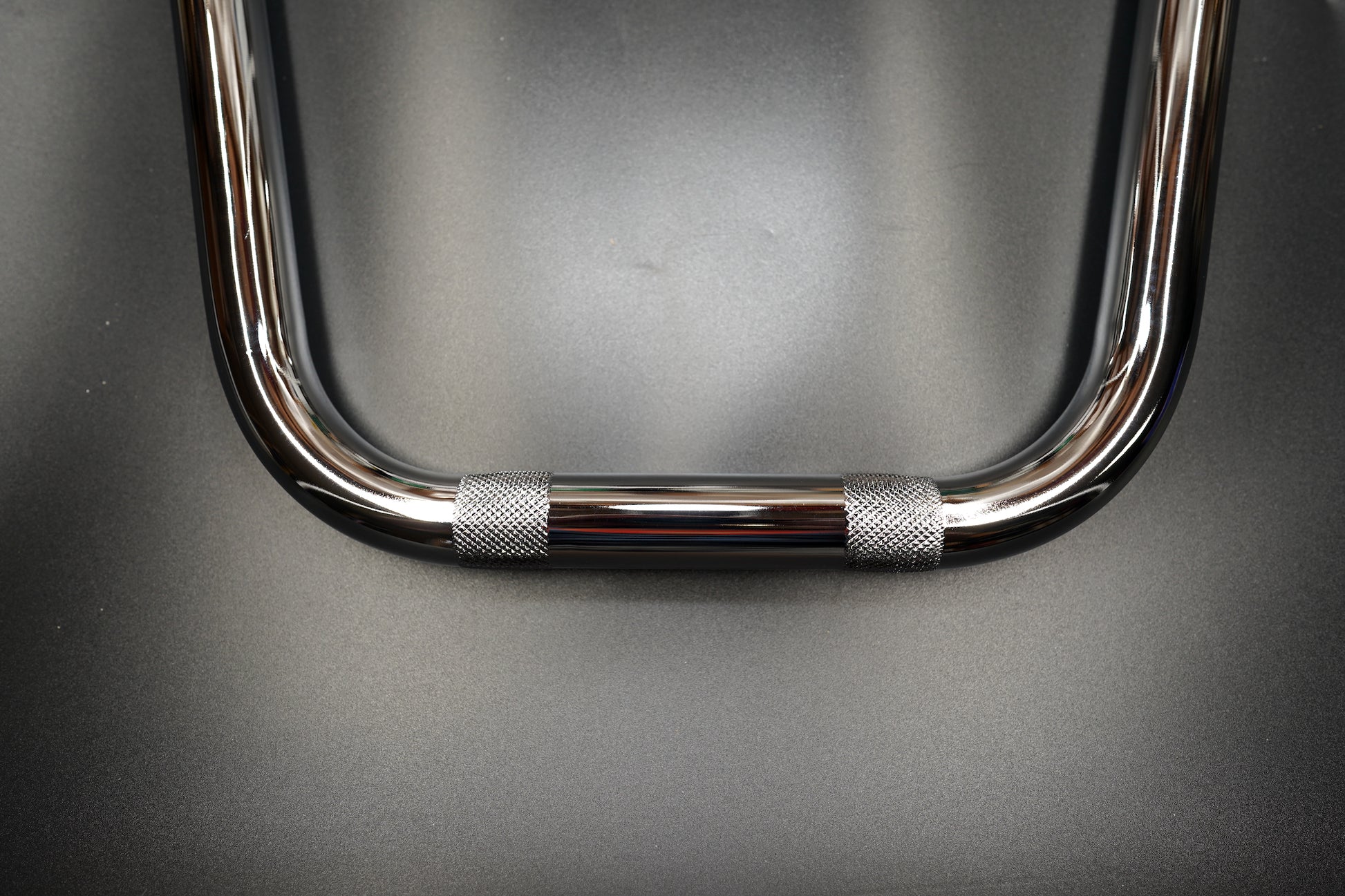 Front view of chrome handlebar showing high-rise design
