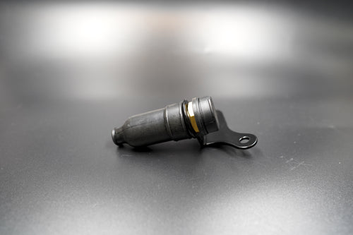 Auxiliary 12V power socket for Triumph Scrambler, laid flat on matte background