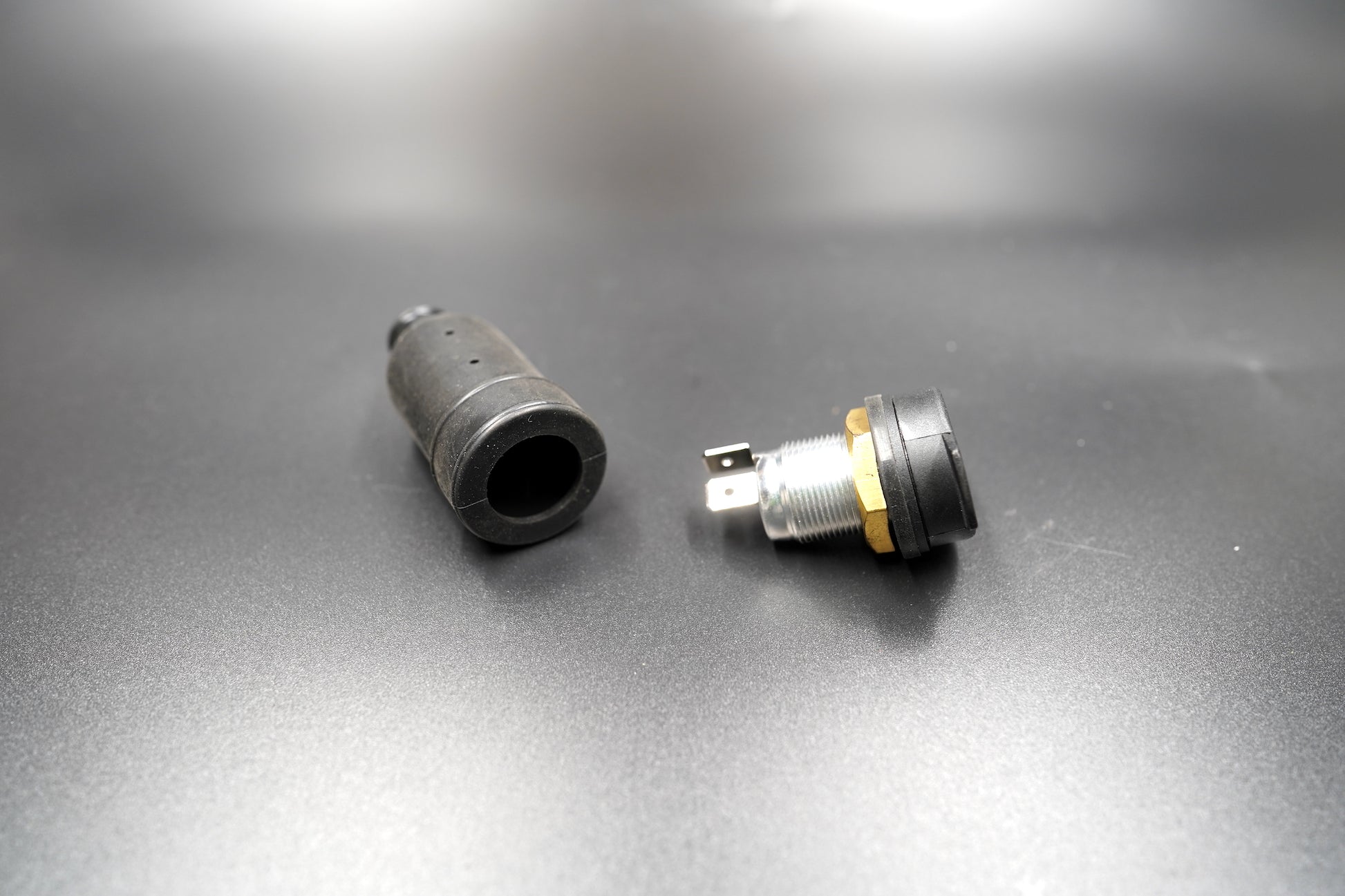 Power socket with threaded nut and waterproof cap shown separately 