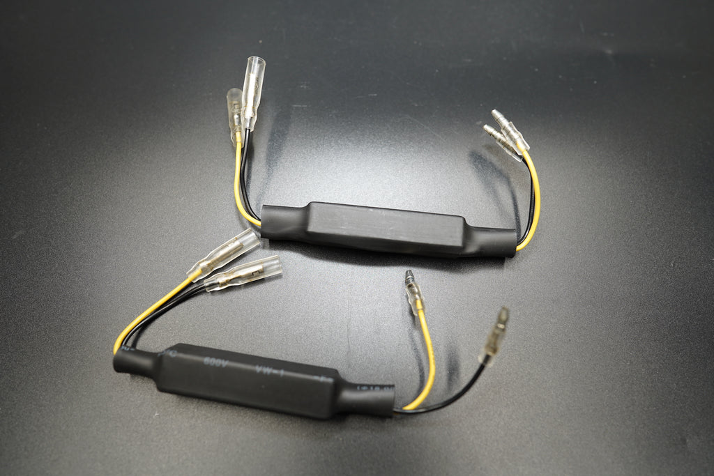 Close-up of BMW R NineT CANBUS error-free resistors with black housing and yellow wires