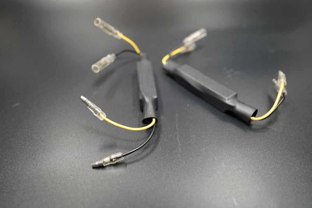 Close-up of BMW R NineT CANBUS error-free resistor pair with black casing and clear terminals