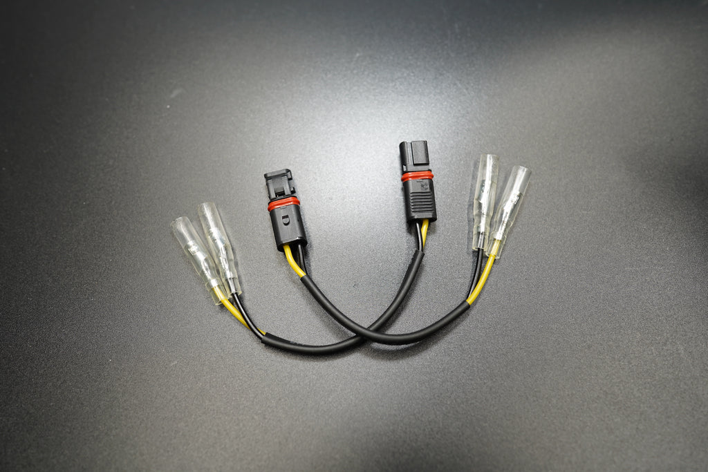 BMW R NineT plug and play LED turn signal connectors with CANBUS-safe design on dark background