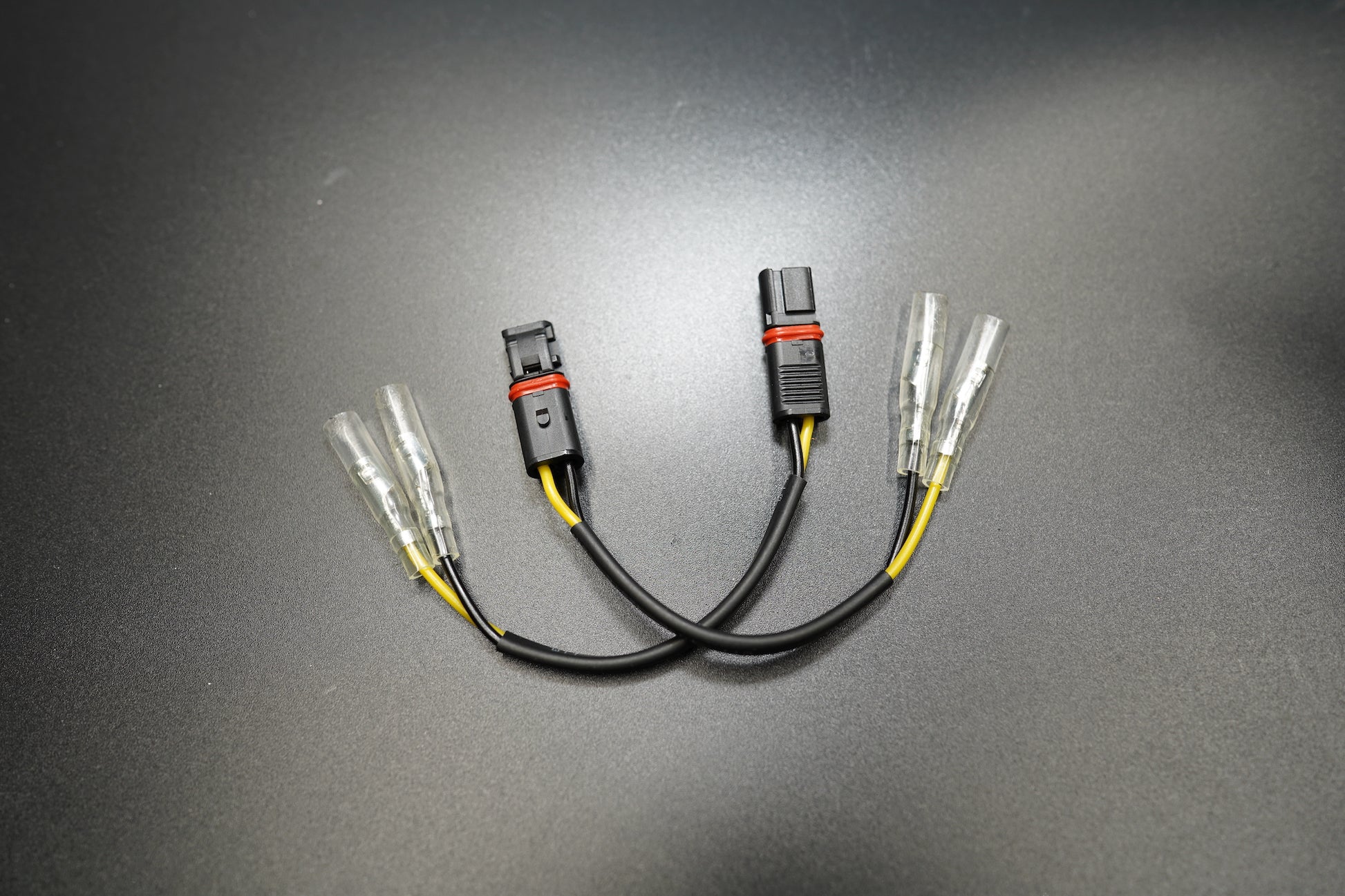 BMW R NineT plug and play LED turn signal connectors with CANBUS-safe design on dark background