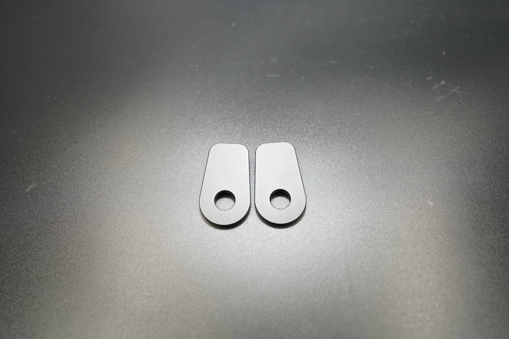 Close-up of BMW R NineT turn signal spacers highlighting anodized finish and precision fit 