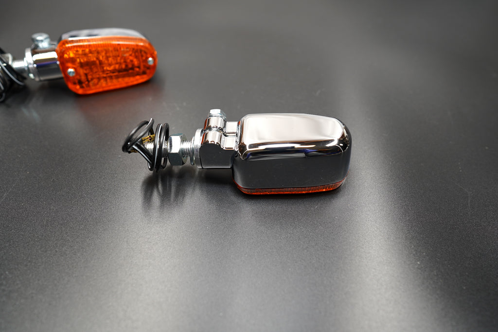 Close-up of amber lens texture and chrome housing detail — durable and elegant.