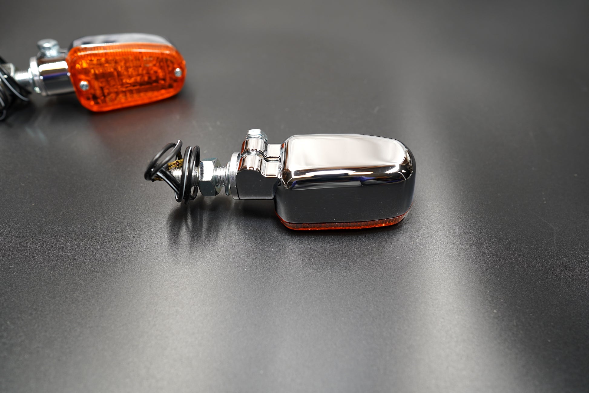 Close-up of amber lens texture and chrome housing detail — durable and elegant.