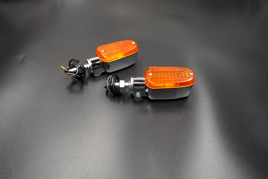 Pair view showing compact build and polished chrome casing with coiled black wires