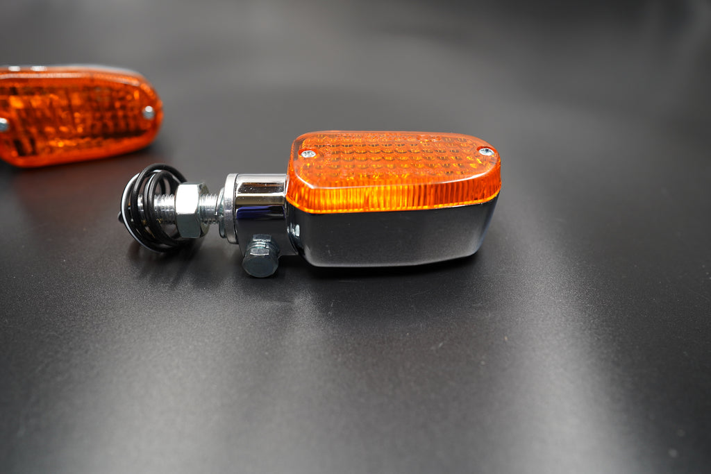 Side angle view showing chrome body and amber rectangular lens design for vintage aesthetic.