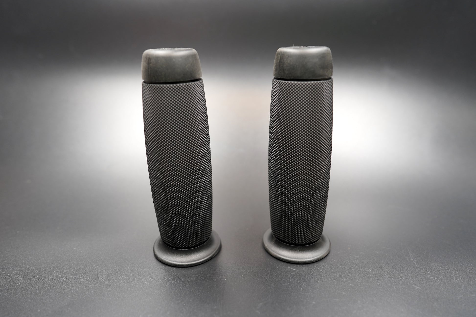 Pair of left and right black grips standing upright — 7/8" universal fit for vintage and modern bikes.