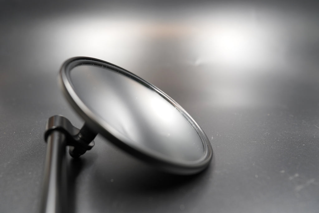 Flat lay view on matte background — showing head curvature and reflection clarity.