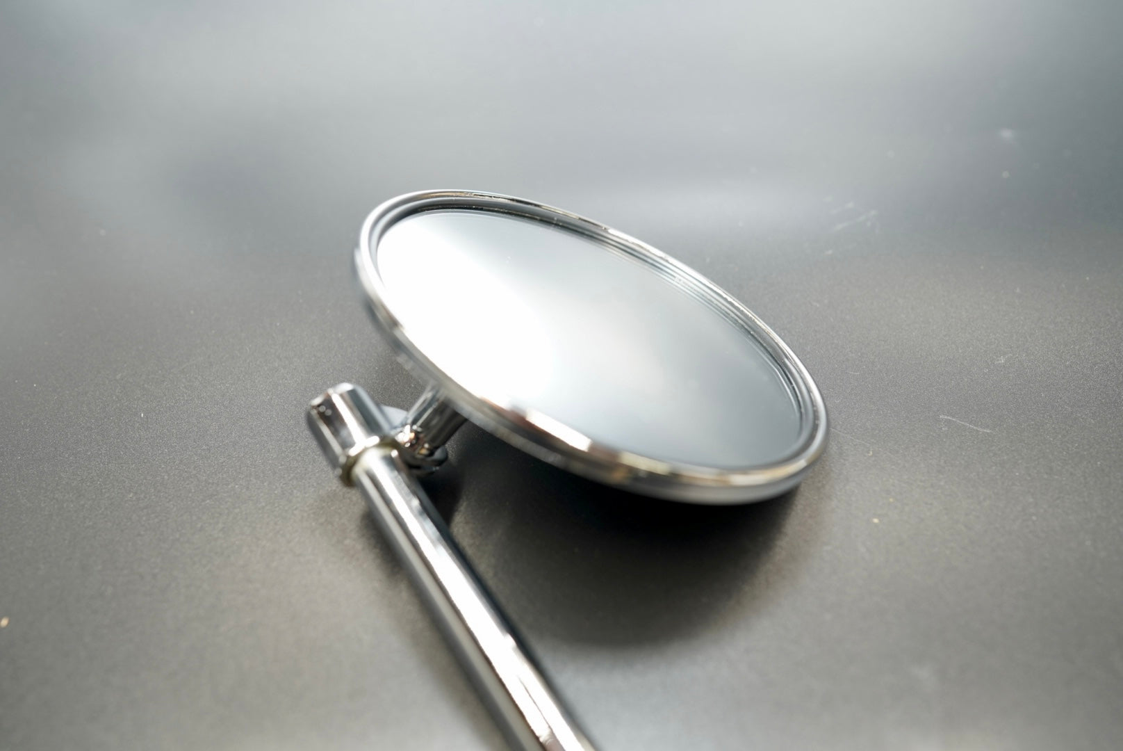 Front view showing round glass face and slim mirror stem — timeless and functional.