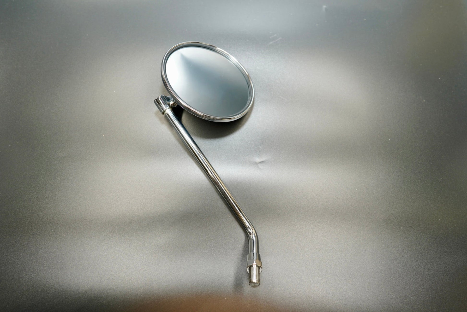 Front angled view of classic round motorcycle mirror in chrome finish — minimalist, vintage-inspired design.