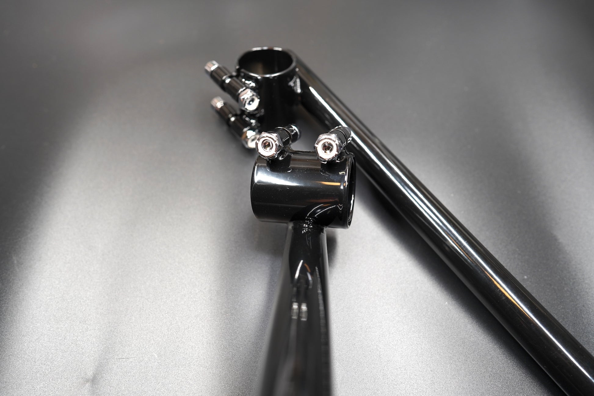 Flat lay of handlebar set arranged diagonally on grey matte background.
