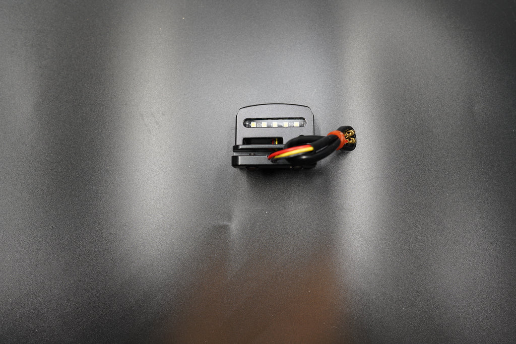 Side angle showing clamp-on mounting bracket and LED housing detail.