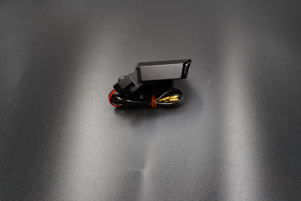 Top-down view showing compact form and subtle smoked lens design.