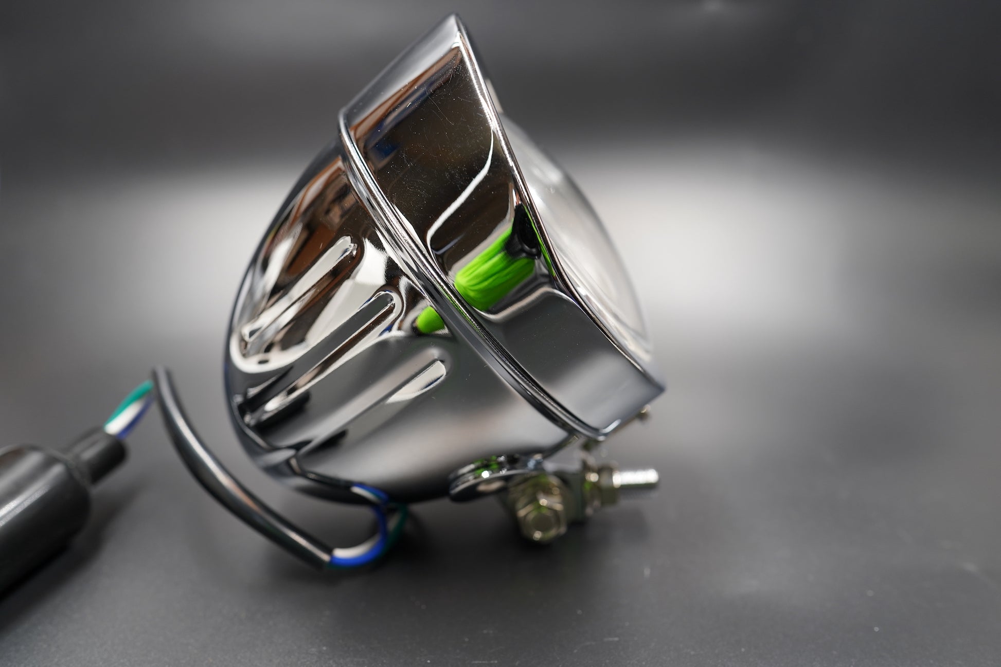 Rear shell view highlighting chrome fins and wiring port.