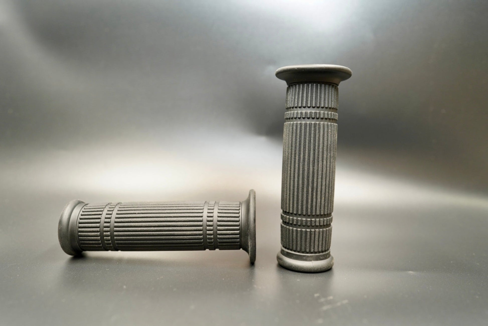 Front view of black ribbed handlebar grips — classic 22mm motorcycle grips with vintage-inspired texture.