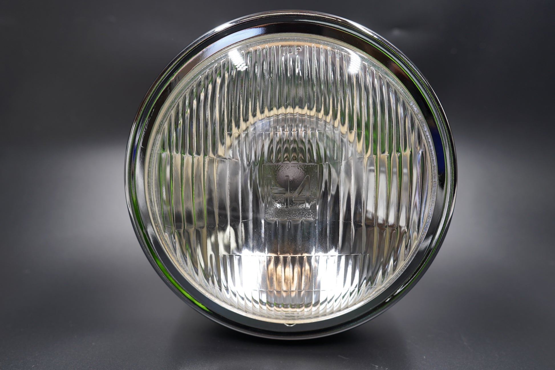 Close-up showing brushed metal trim and clear lens surface detail.