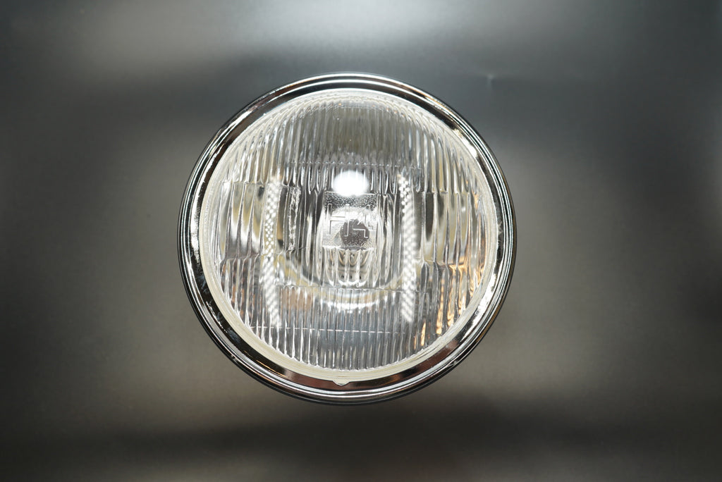 Straight-on view showing clear plastic lens and vintage circular grid pattern.