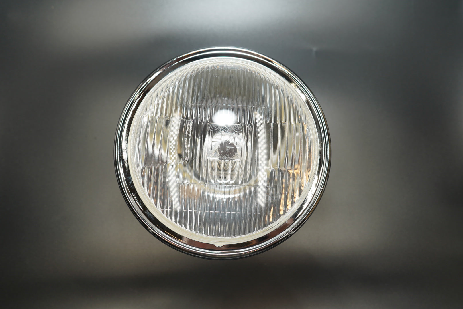 Straight-on view showing clear plastic lens and vintage circular grid pattern.