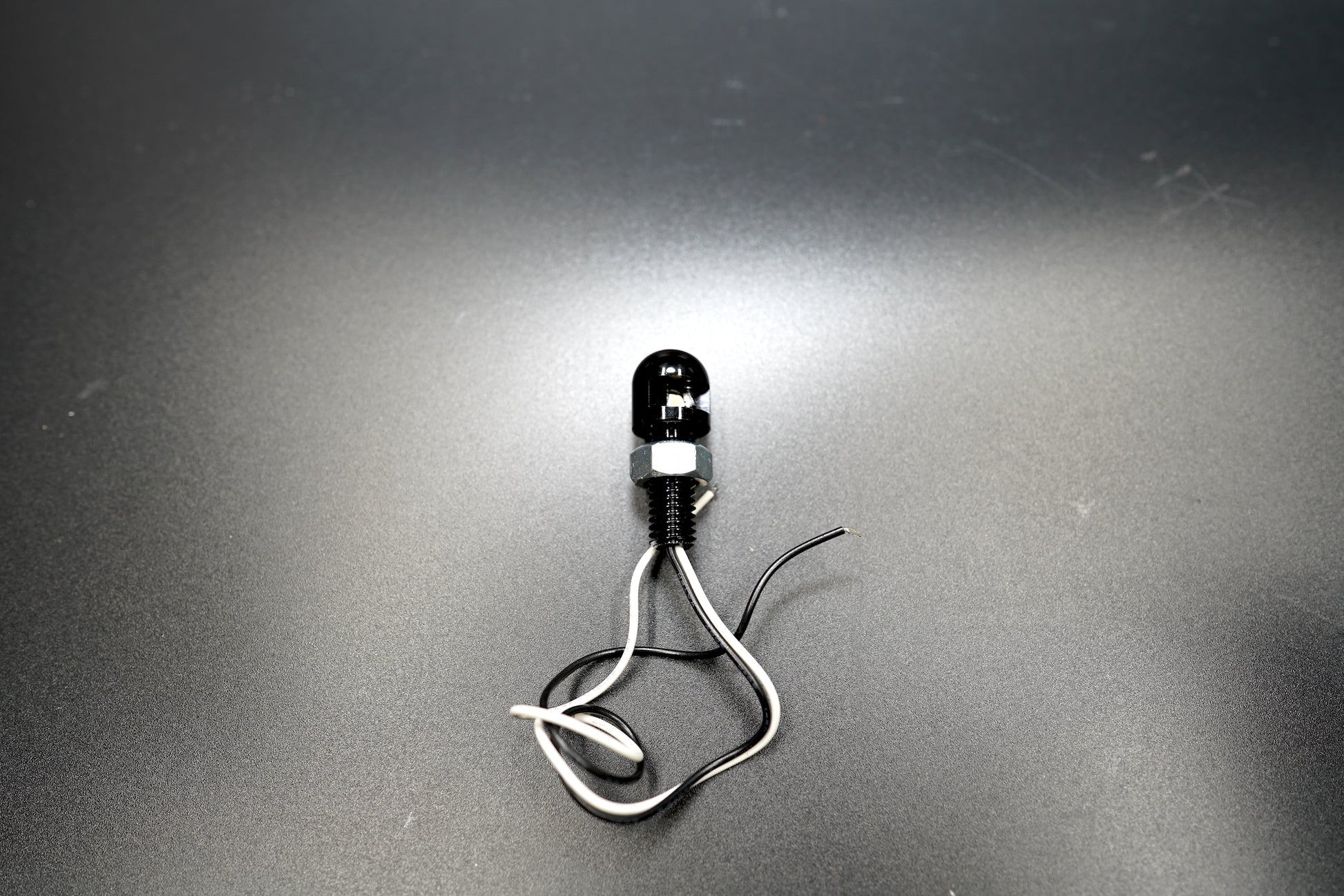 Front view highlighting clear LED lens and clean light output point.