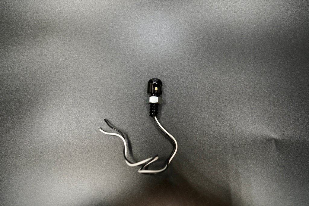 Compact Eagle Eye LED motorcycle license plate lamp with minimalist black aluminum body and white wire leads.