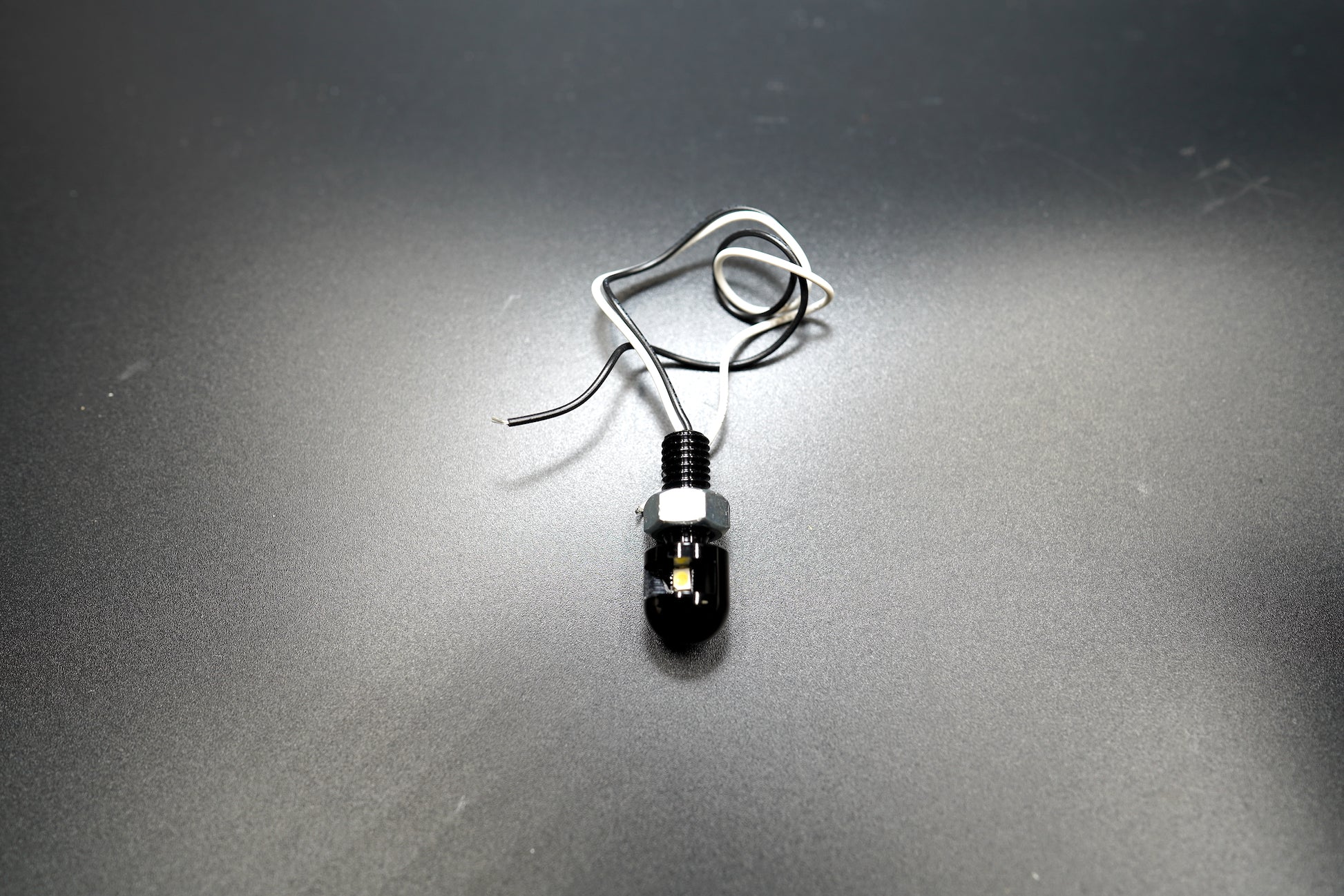 Top-down view showing the compact cylindrical shape and smooth black anodized finish.