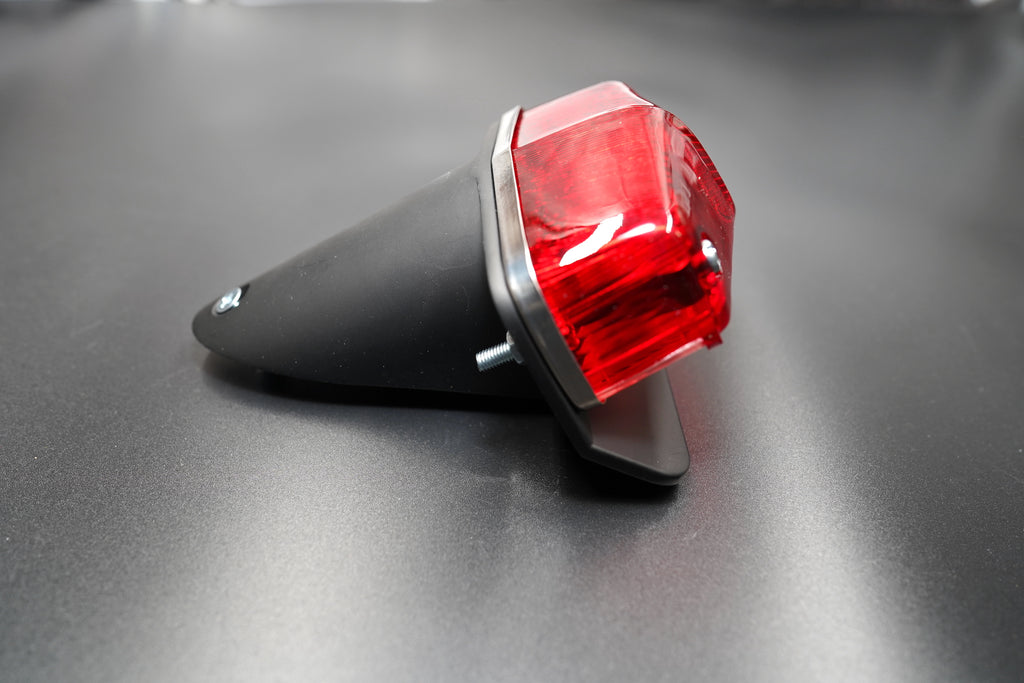 Three-quarter perspective showing integrated license plate mount and clean welded frame.