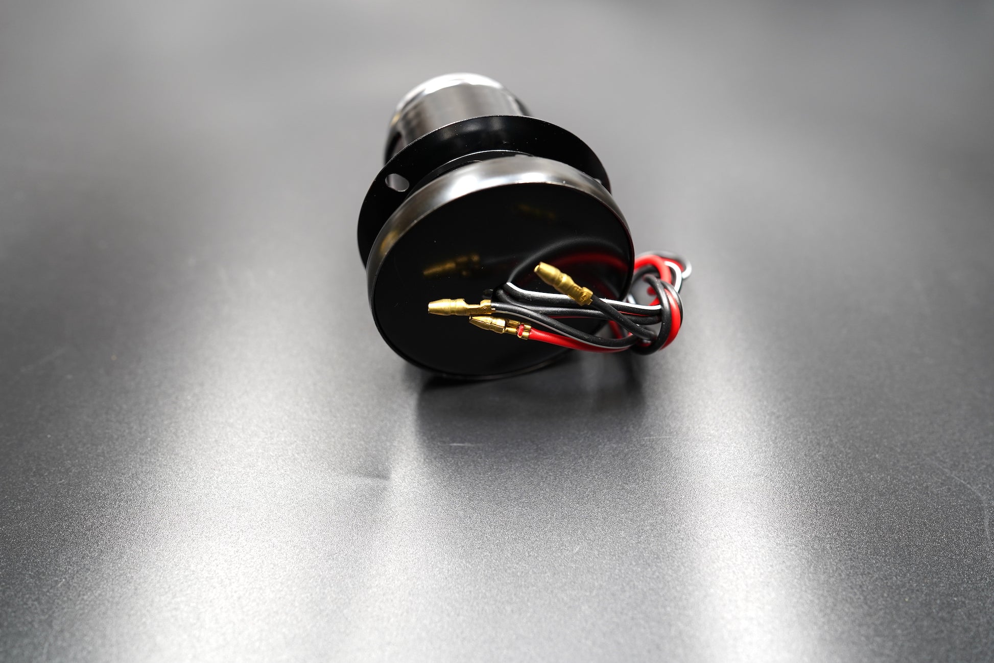 Bottom view showing mounting bolts and wire exit — ready for installation.