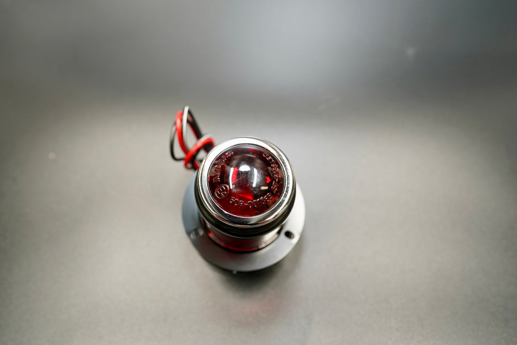 Front view highlighting red glass lens and vintage MT110 proportions — timeless British design.