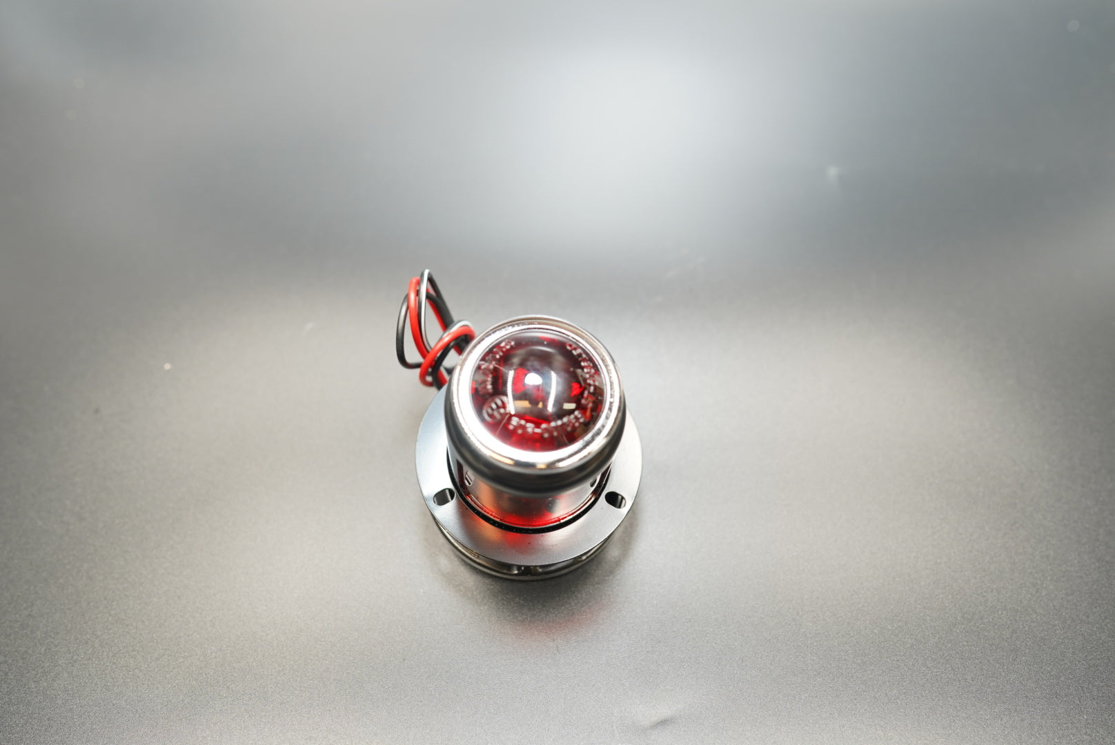 Side angle showing alloy body and clear side windows — soft ambient glow for café racer builds.