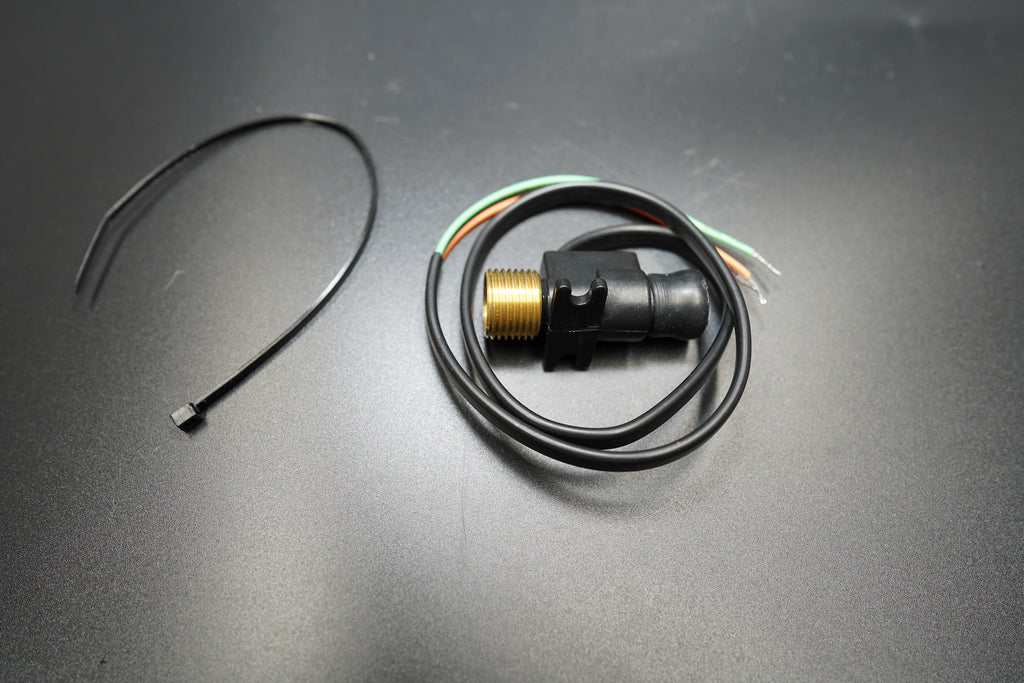 Top-down shot highlighting circular metal body and wiring tail.