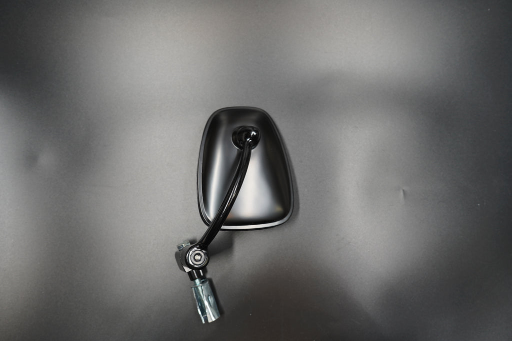 Flat lay of single mirror and mounting hardware on matte background.