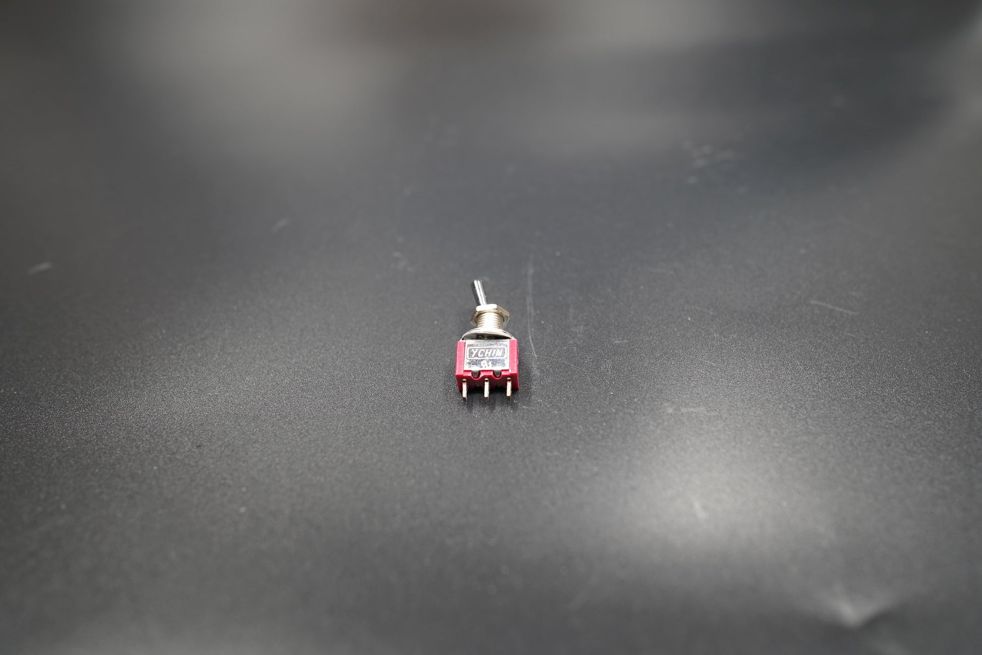 Switch with red safety cover open on grey background