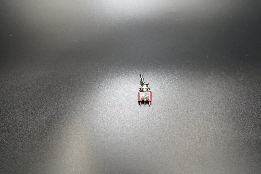 Tilted top-down view emphasizing toggle handle and finish