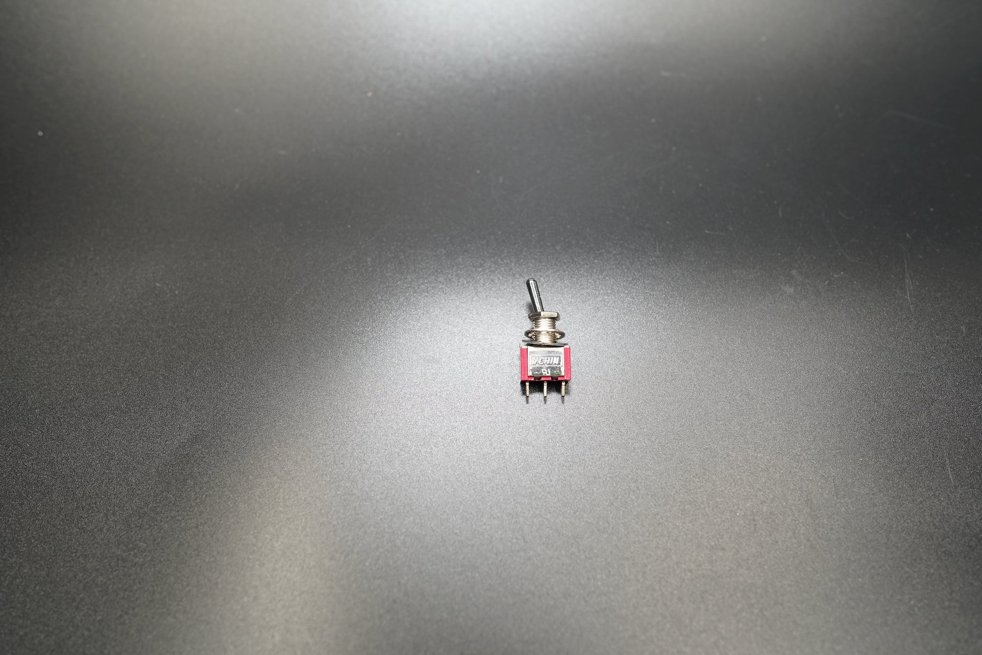 Tilted top-down view emphasizing toggle handle and finish