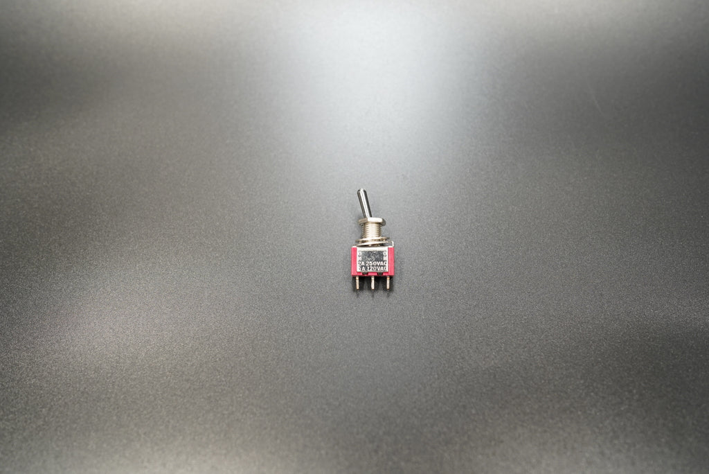  Top view of toggle switch showing lever and mounting nut