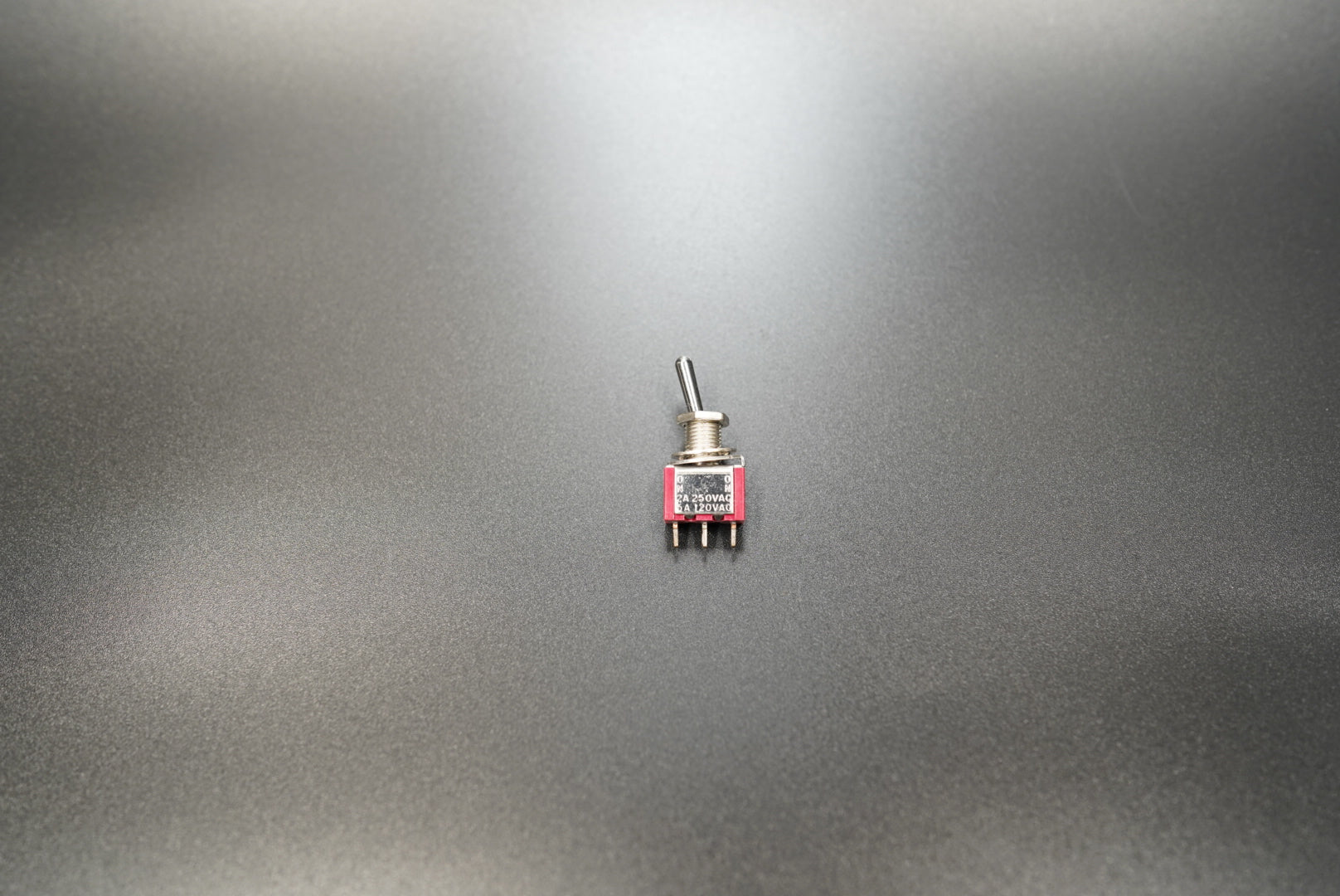  Top view of toggle switch showing lever and mounting nut