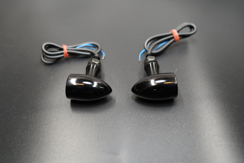 Mini LED turn signal set in black anodized finish with wiring shown on dark background
