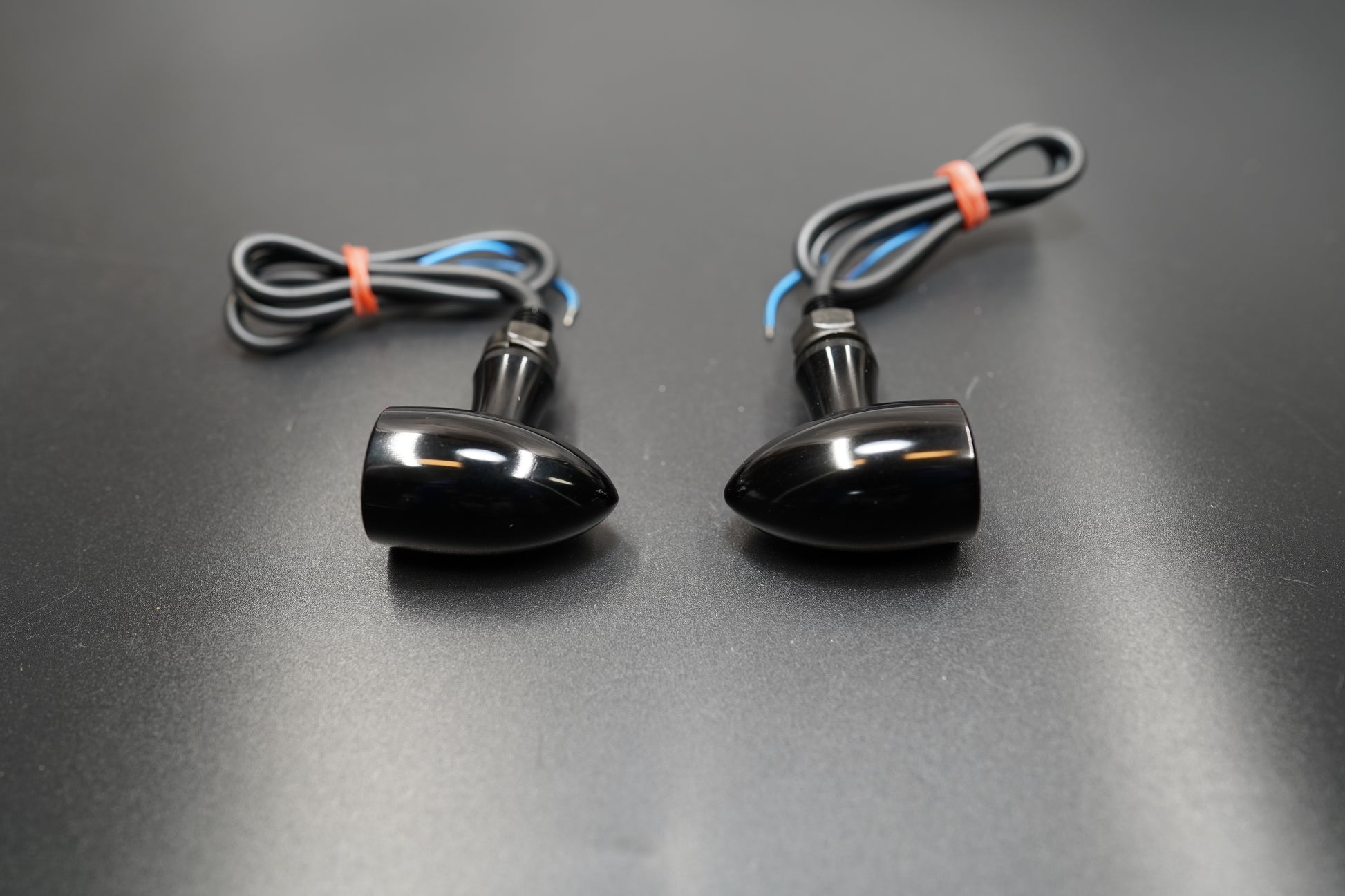 Mini LED turn signal set in black anodized finish with wiring shown on dark background