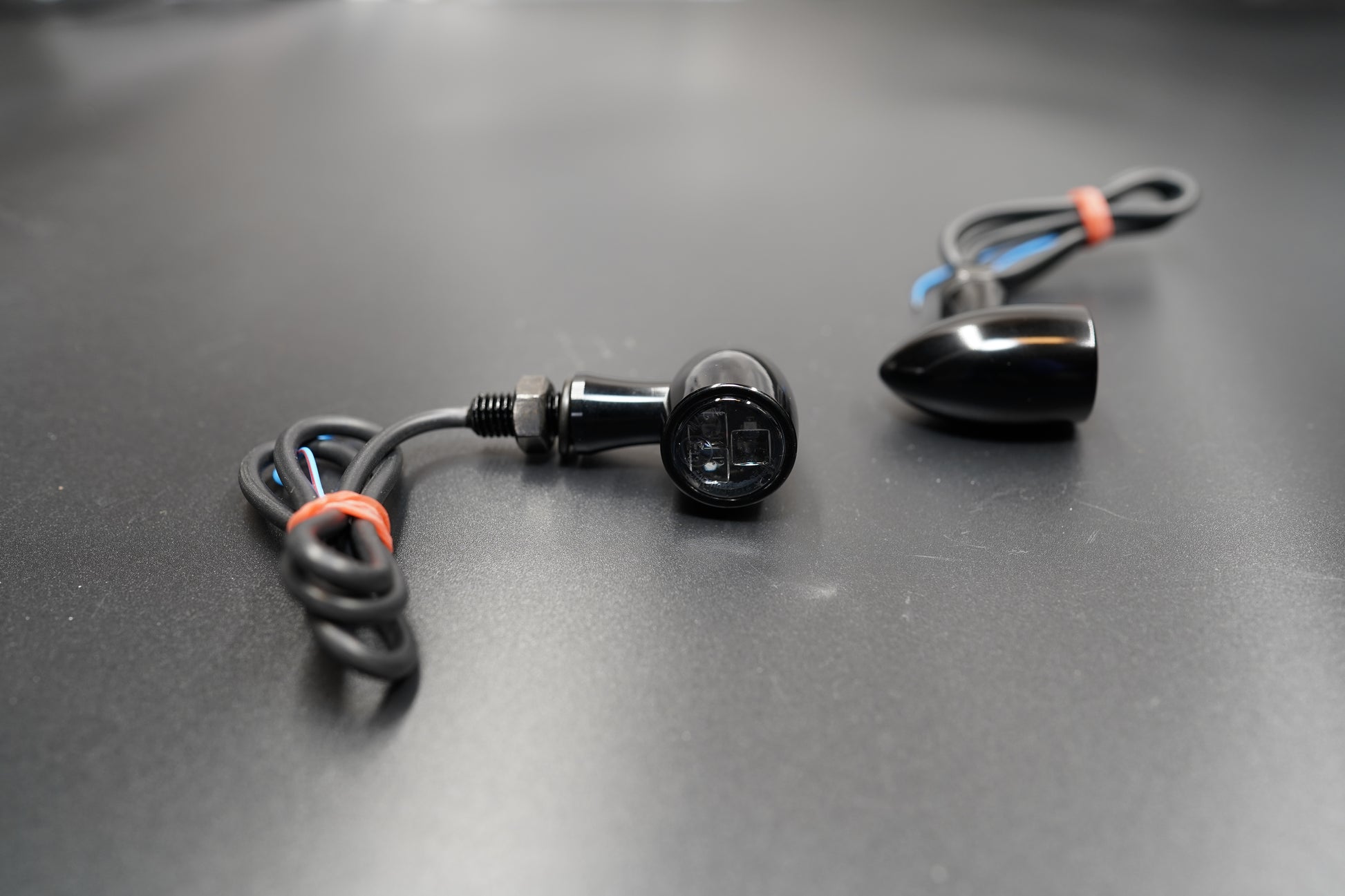 Close-up of single mini LED turn signal showing compact bullet shape and wire leads