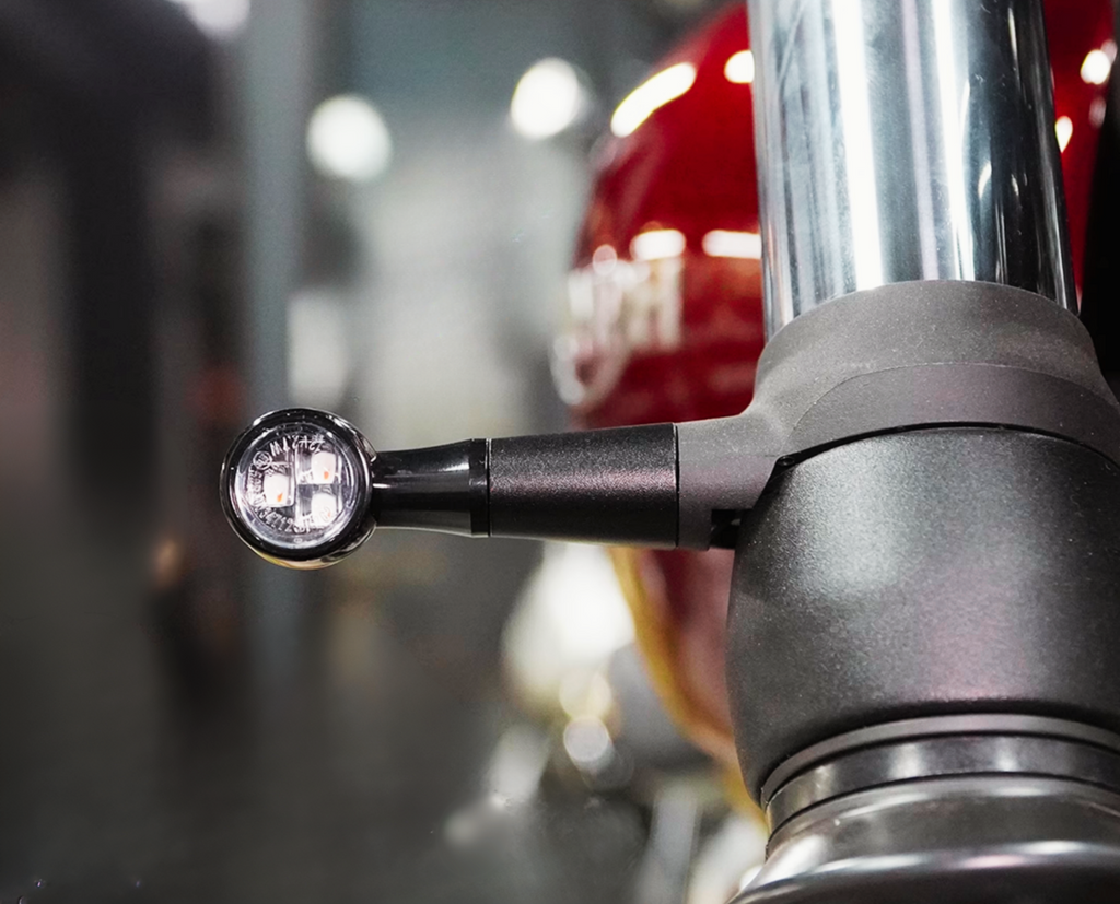 Close-up of mini LED turn signal installed on Triumph fork bracket 