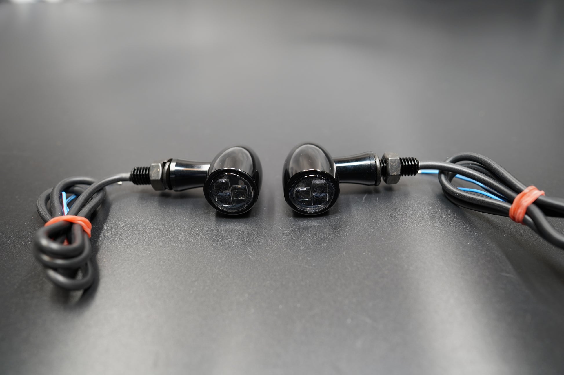 Rear view of mini LED turn signals showing thread mount and wiring exit 